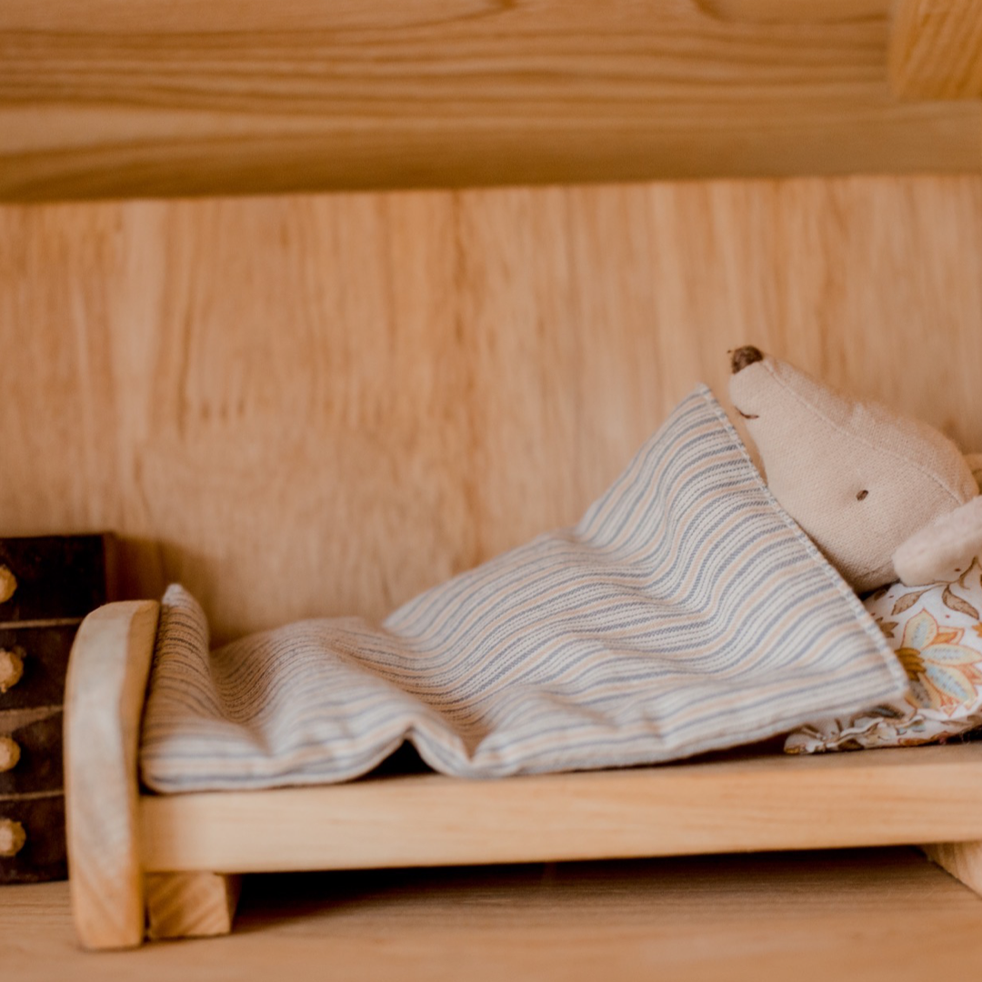 Mouse lying in bed inside two storey cottage house from QToys