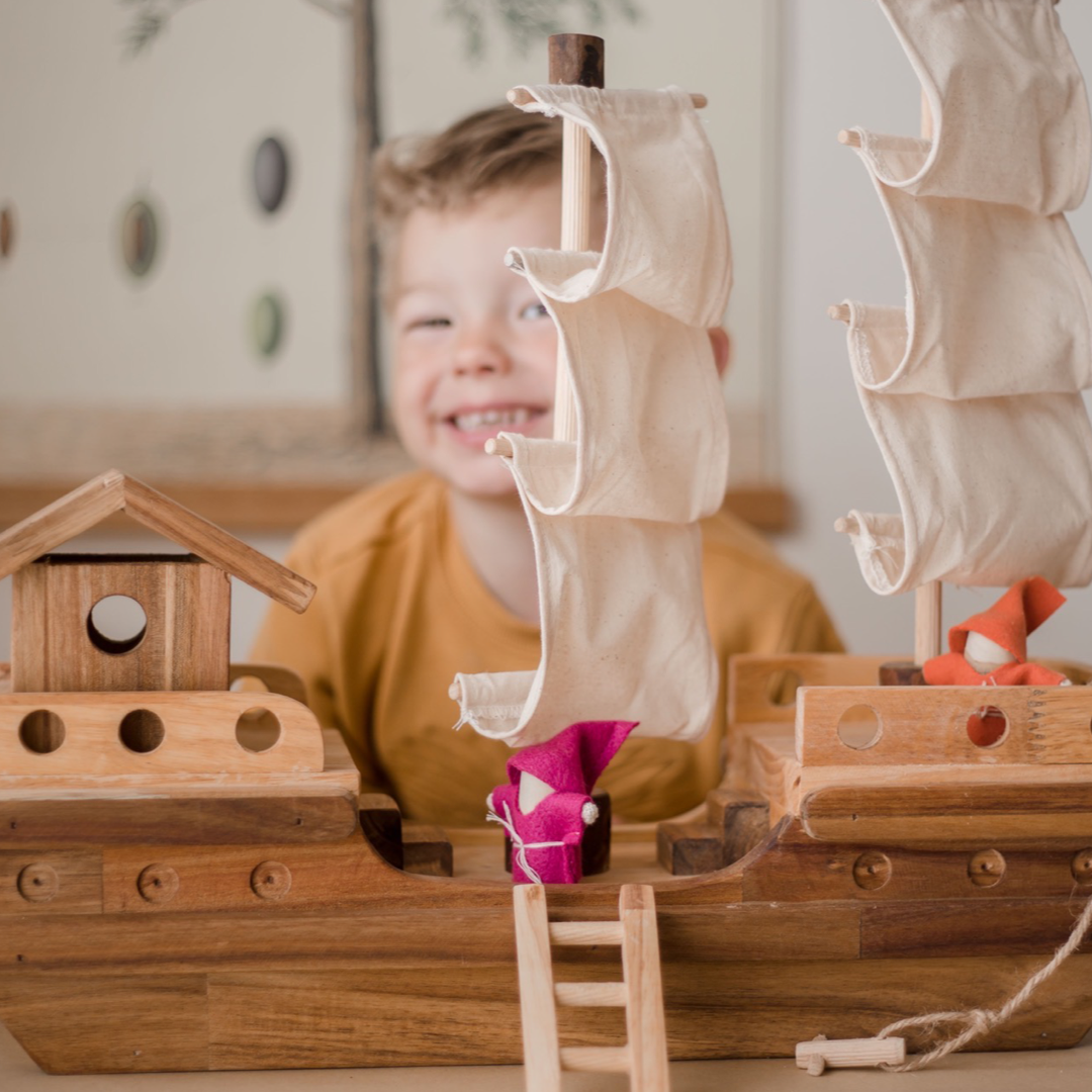 Boy playing with pirate ship from QToys