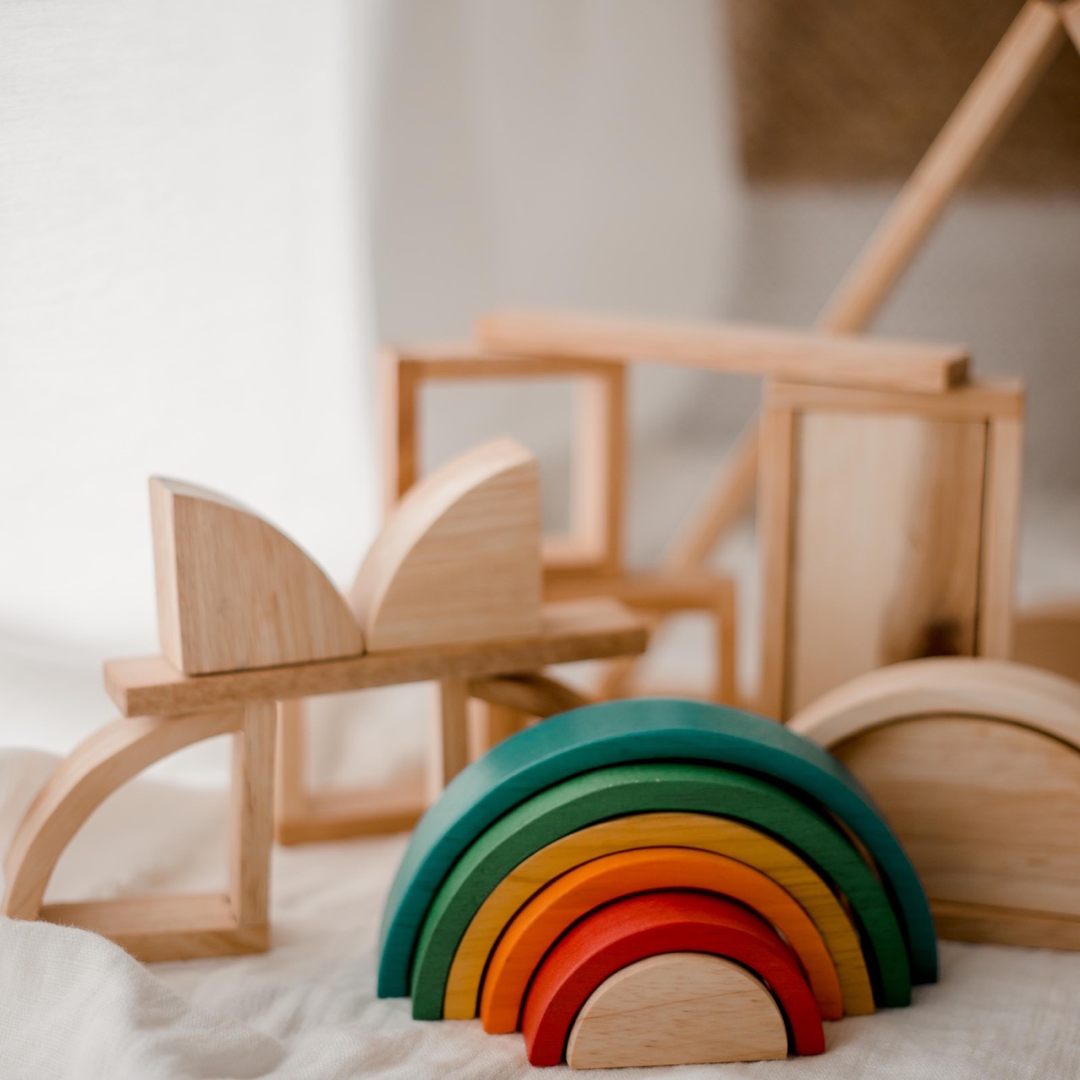 Wooden blocks from QToys displayed showing the colourful wooden rainbow of red, orange, yellow, green and blue