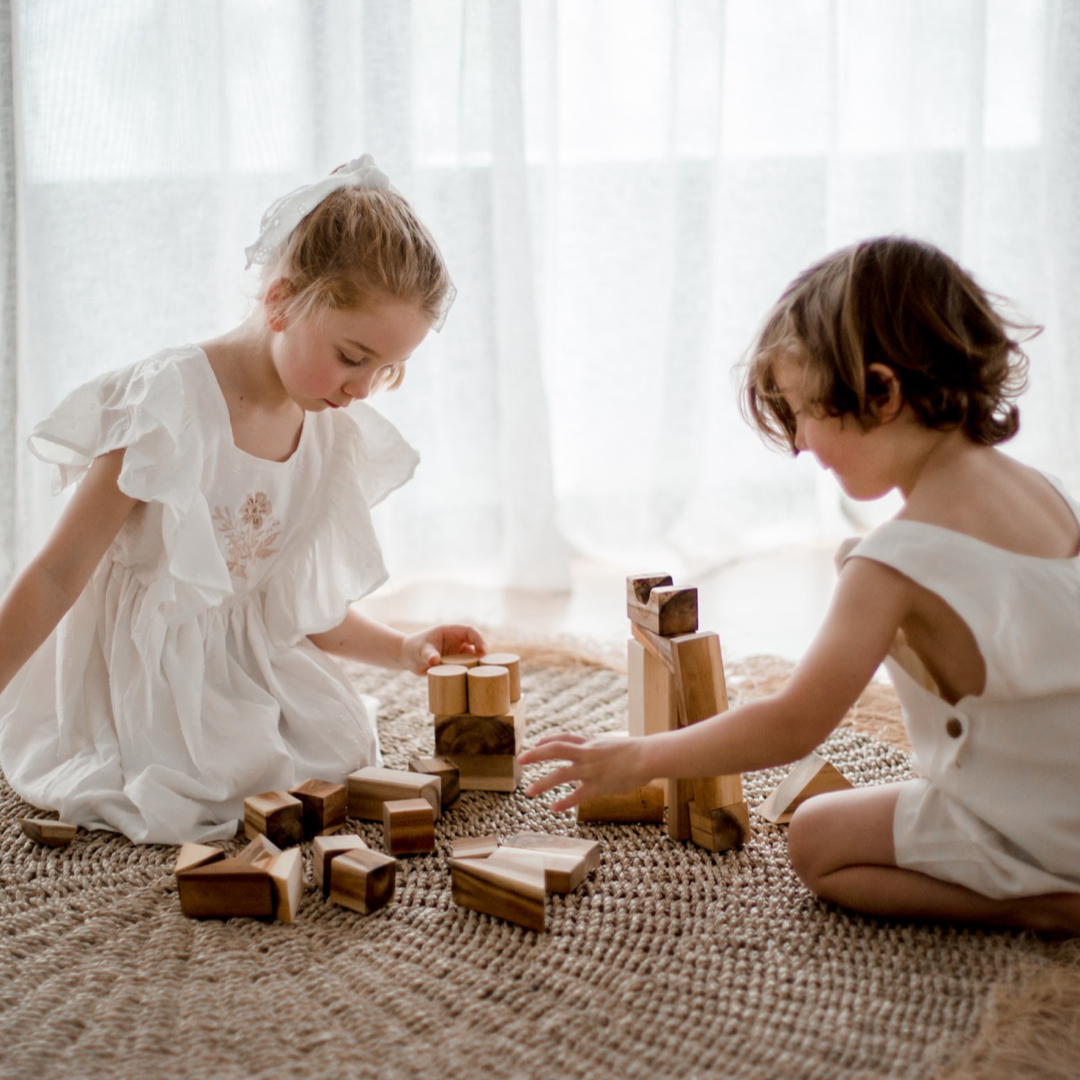 Children playing with building blocks from QToys