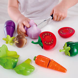 Wooden pretend play food being cut in half during role play