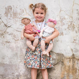 Young girl holding baby Aria and friend doll from Bonikka doll range by Tikiri Toys looking very happy