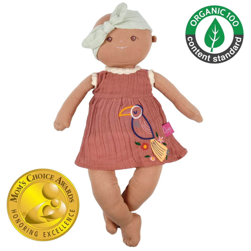 Bonikka doll baby Aria: Soft fabric doll with dusky pink muslin dress and pastel geeen headband.  Brown eyes and embroided toucan on her dress. Moms choice award winner and organic 100 standard stamp