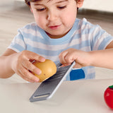 Boy grating potato on grater of Hape cooking essentials play set.