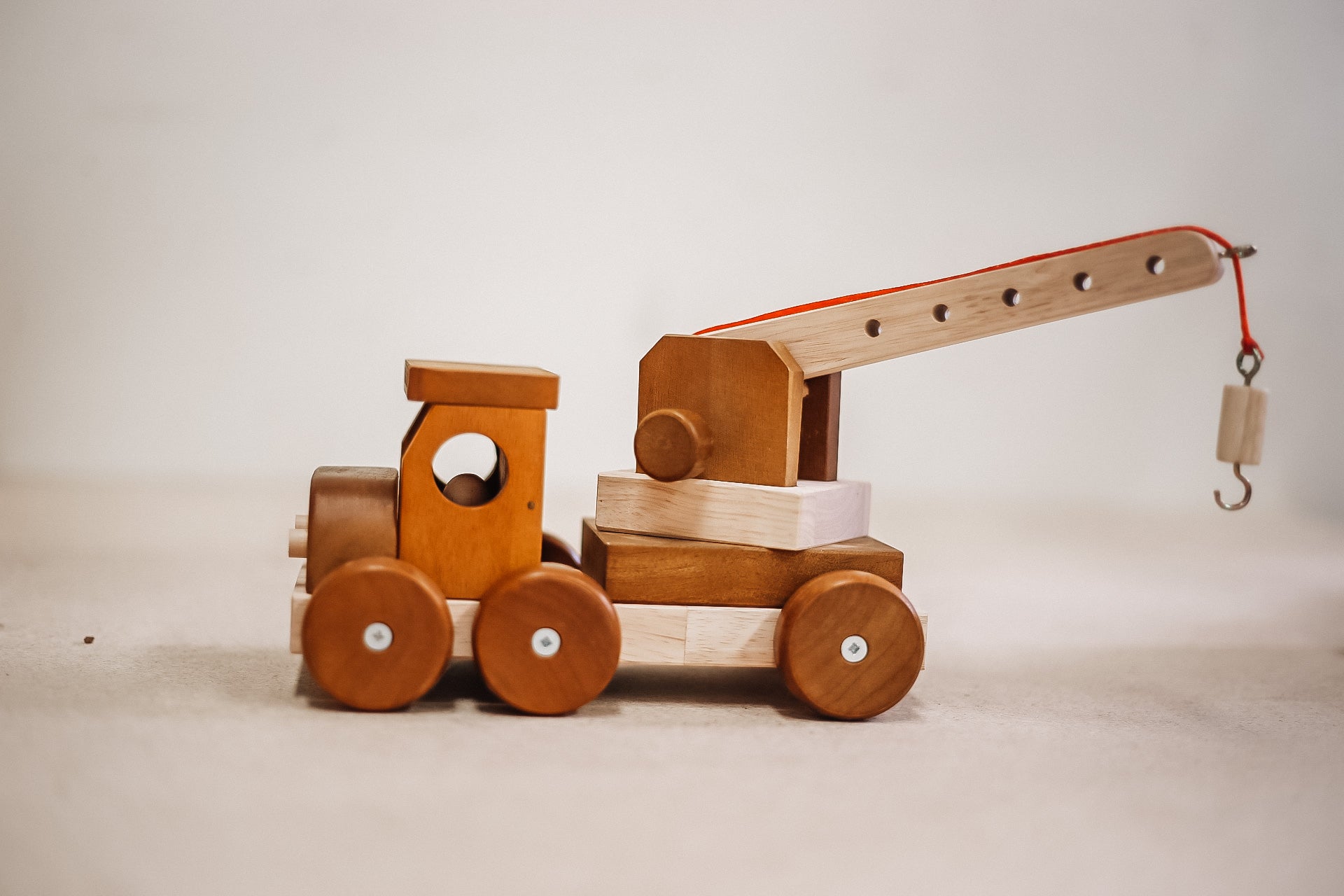 Wooden crane from QToys with hook on end of moving crane