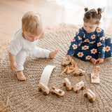 Girl and boy playing with cars and trucks from wooden vehicle play set from QToys