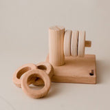 A wooden horizontal stacker from Qtoys, with 3 smaller rings and 3 larger rings