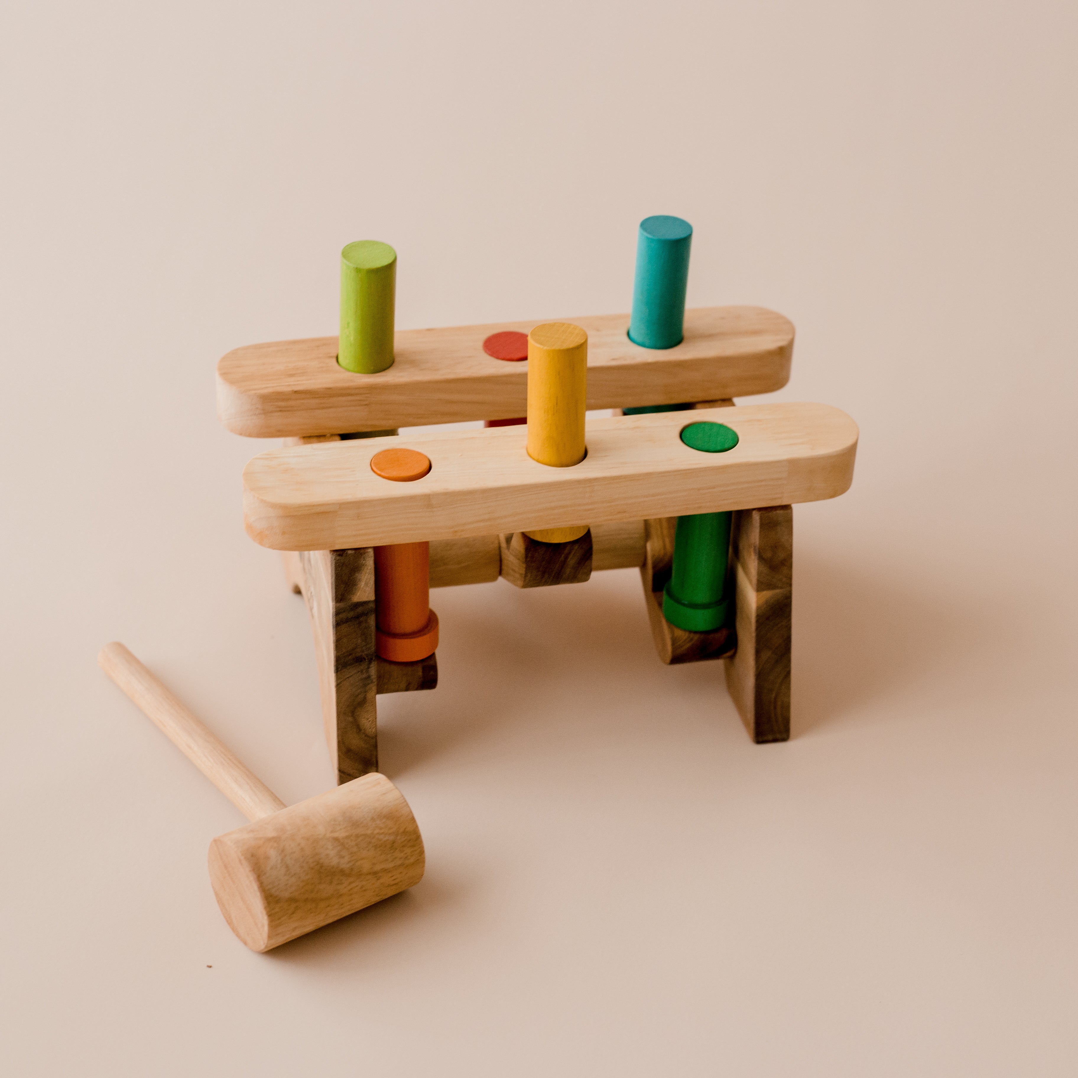Beautiful Pound a Peg wooden hammer and peg toy from QToys. Pegs are in green, orange, blue, red and yellow. Pegs connected to one another so when one goes down the other goes up.