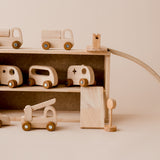 Wooden vehicles parked in garage which is also the storage box from QToys Vehicle play set