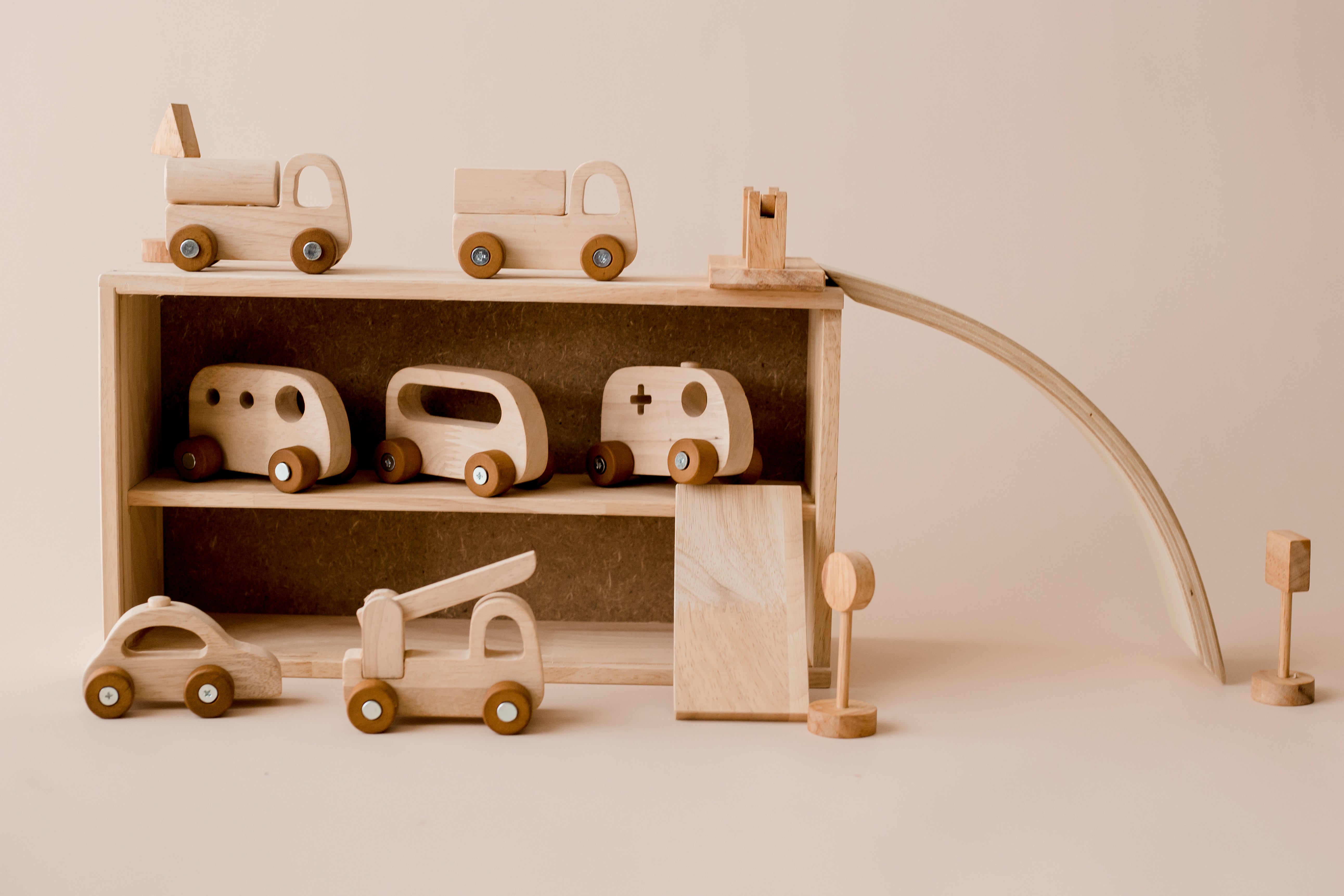 Wooden vehicles parked in garage which is also the storage box from QToys Vehicle play set