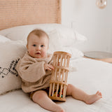 Baby playing with wooden rainmaker from QToys