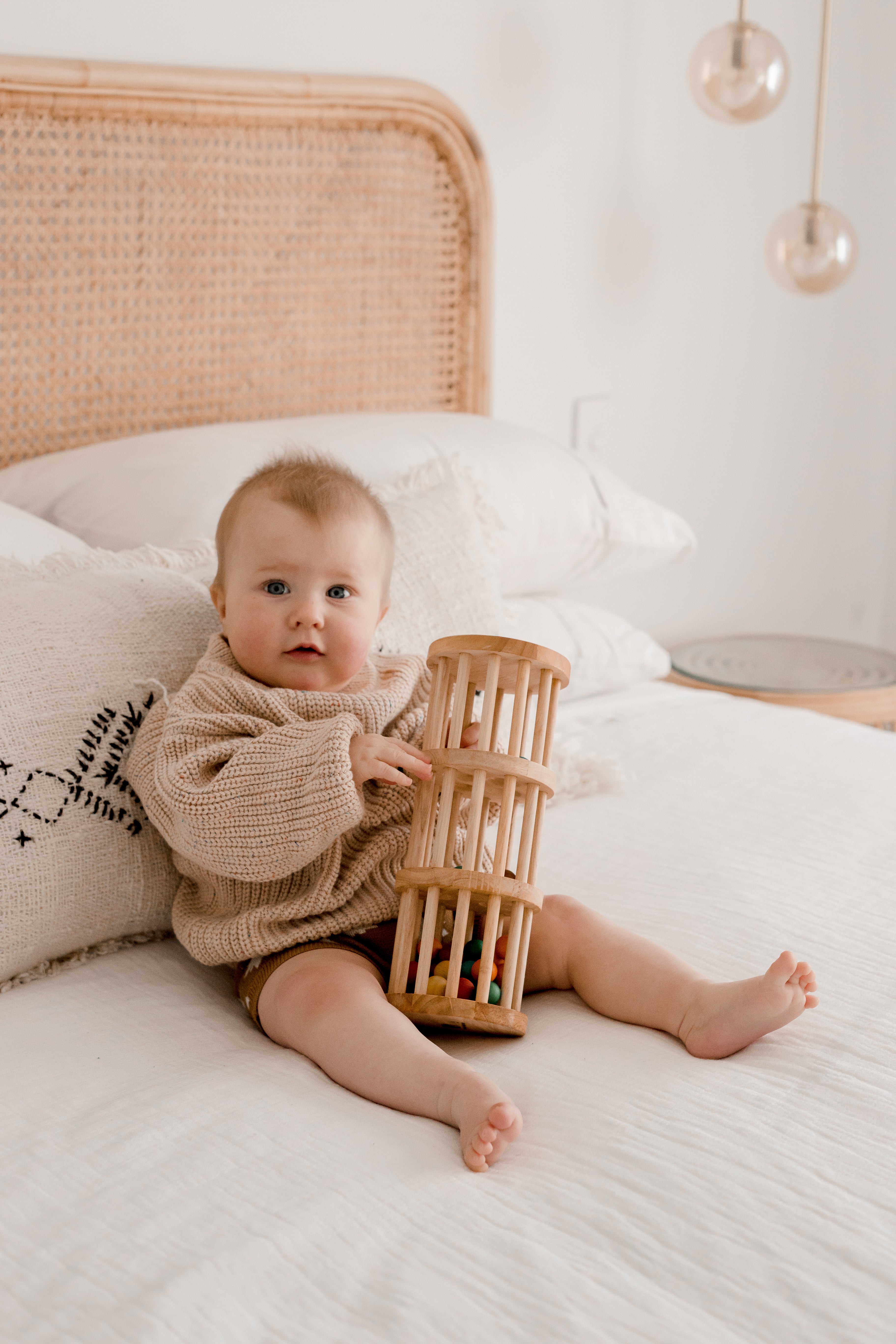 Baby playing with wooden rainmaker from QToys