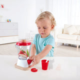 Boy playing with Hape smoothie blender set pretending to make a smoothie