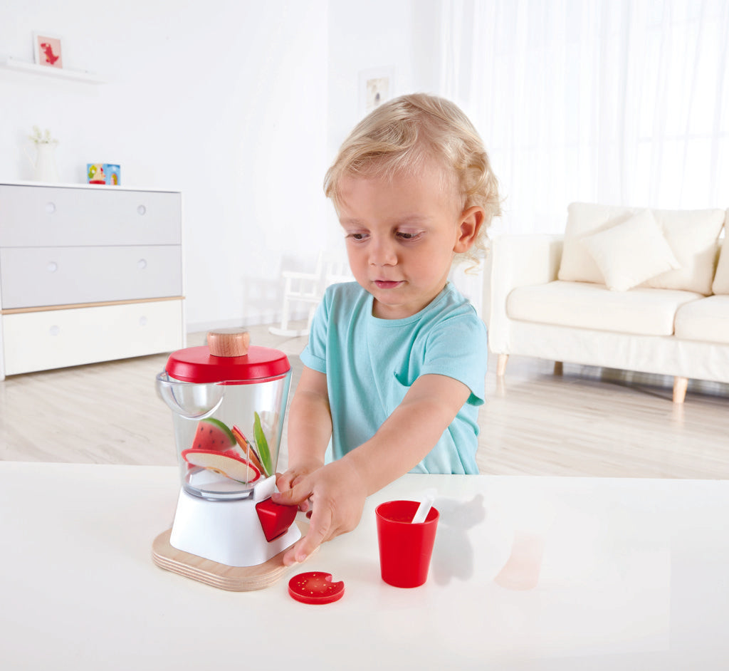 Boy playing with Hape smoothie blender set pretending to make a smoothie